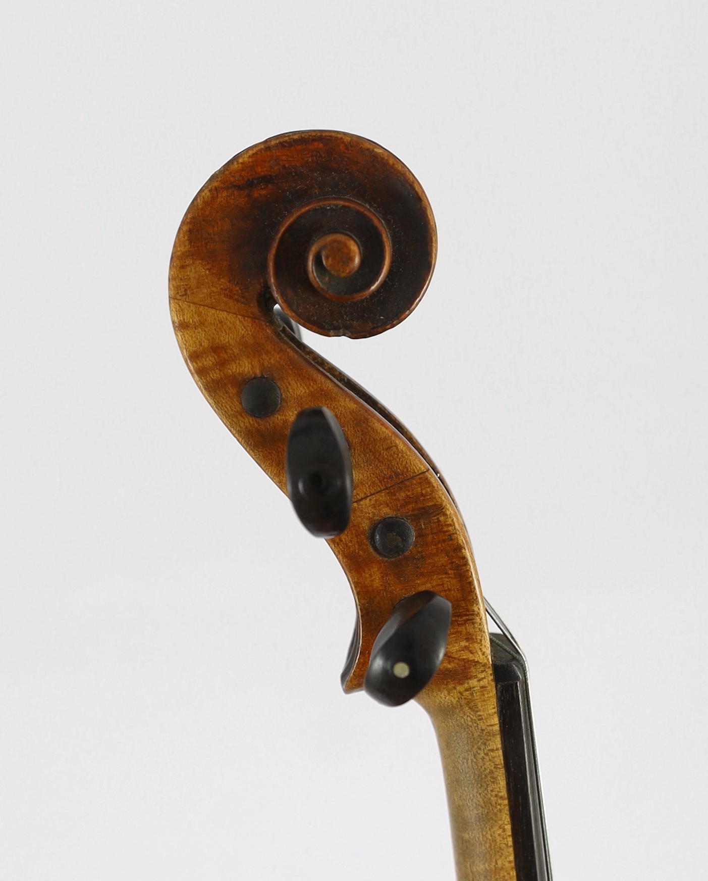 An 18th century violin, labelled ‘New Back by James Carroll, Maker, Manchester 1899’, length of back 36.5cm